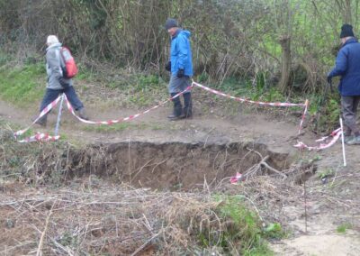 Photo of walkers diverting around a sink hole