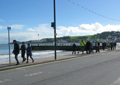 Photo of walkers on Swanage seafront – March 2, 2024