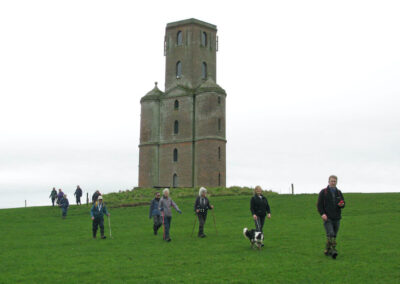 Photo of walkers passing Horton Tower – March 16, 2024