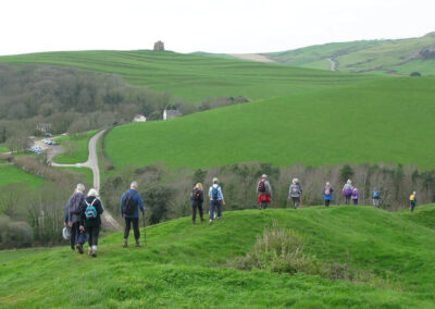 Photo of walkers with St Catherine's Chapel in the distance (2) – March 20, 2024
