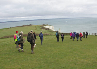 Photo of walkers on descent from Ballard Down towards Old Harry – April 3, 2024