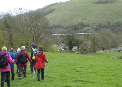 Photo of walkers approaching the National Trust Castle View Welcome Centre with a diesel multiple unit on the Swanage Railway in the background – April 6, 2024
