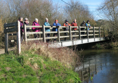 Group photo of walkers on bridge across the River Piddle – March 1, 2025