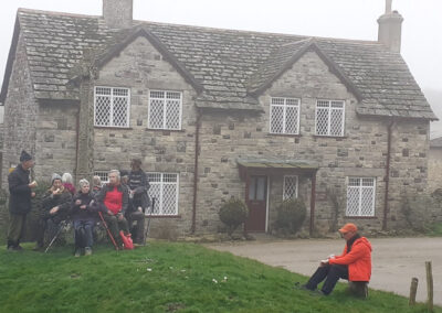 Photo of walkers taking a breather at the cross in Studland – March 5, 2025