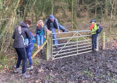 Photo of walkers climbing over a gate – March 8, 2025