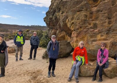 Photo of walkers at Agglestone Rock – March 12, 2025