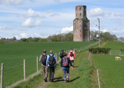 Photo of walkers approaching Horton Tower – April 16, 2025