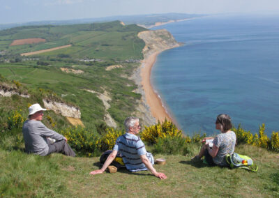 Photo of walkers taking a rest break on top of Golden Cap – May 3, 2025