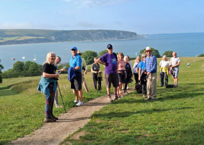Group photo with Swanage Bay in the background – June 12, 2025