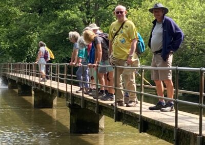 Photo of walkers crossing the footbridge at the ford near Moreton – June 14, 2025