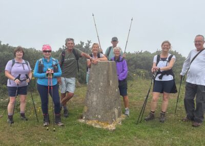 Group photo taken at the trig point on Whiteway Hill – June 28, 2025