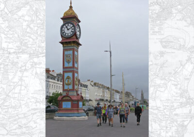 Photo of walkers passing Weymouth's clock tower – July 5, 2025