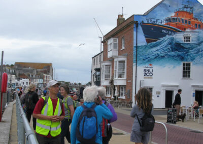 Photo of walkers with RNLI mural in background – July 5, 2025
