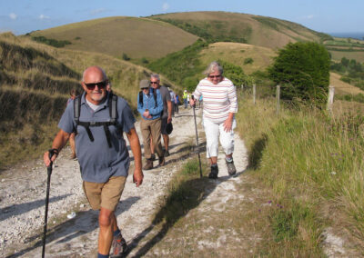 Photo of walkers climbing the track towards Knitson Farm – July 14, 2025