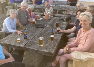 Photo of walkers enjoying post-walk refreshments at the Square & Compass in Worth Matravers – July 28, 2025