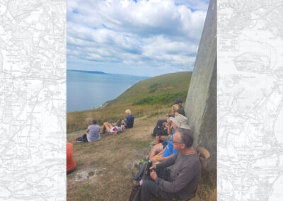 Photo of group taking a break at the navigational beacon on the coast path – July 30, 2025