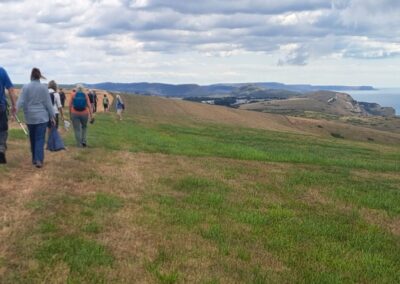 Photo of walkers with coastline in the distance – July 30, 2025
