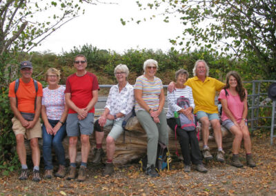 Photo of group of walkers sitting on a log – August 20, 2025
