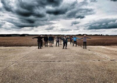 Photo of walkers on the deserted and windswept runway of the former Tarrant Ruston airfield (home to Halifax bombers and military gliders during World War II) – October 18, 2025