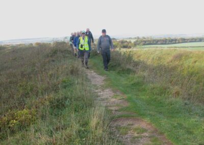 Photo of walkers on the ramparts at Badbury Rings – October 22, 2025