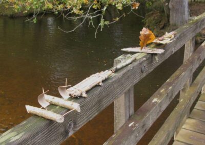 Photo of boats built (with varying degrees of success) to race underneath a bridge during the walk – November 1, 2025