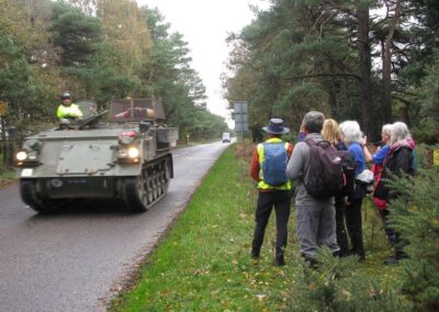 Photo of walkers watching a military vehicle on the road – November 12, 2025