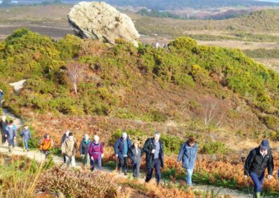 Photo of walkers with Agglestone Rock in the background – December 10, 2025