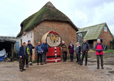 Photo of walkers posing with Christmas themed bales – December 17, 2025