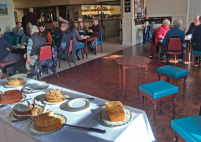 Photo of group members enjoying refreshments at Bloxworth village hall after the walk – February 14, 2026