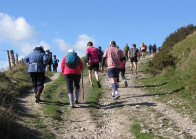 Photo of group members being overtaken by runners taking part in the Jurassic Express Trail Run – March 14, 2026