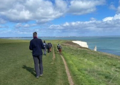 Photo of walkers approaching Handfast Point – March 25, 2026