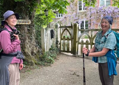 Photo of walkers admiring a splendid display of wisteria at The Old Vicarage near St Nicholas Church in Chaldon Herring – May 2, 2026