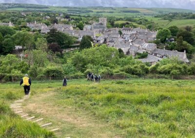 Photo of walkers tackling the very steep descent into Corfe Castle – May 16, 2026