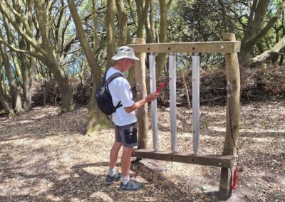 Photo of walker playing the sound tree on the Wild Play Trail at Durlston Country Park – May 23, 2026