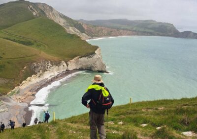 Photo of walkers on the coast path with Worbarrow Bay in the distance – June 7, 2026