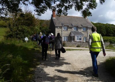 Photo of walkers passing Whitecliff Farmhouse – June 10, 2026