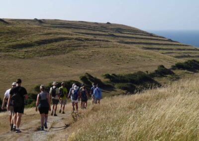 Photo of group near Winspit with strip lynchets visible on the hillside – July 11, 2026