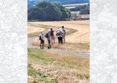 Photo of walkers looking across towards Abbot’s Court Dairy – July 25, 2026