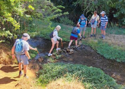 Photo of walkers crossing stream – August 1, 2026