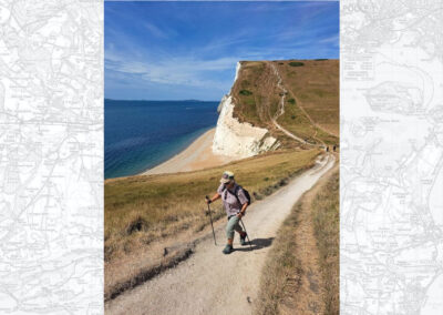 Photo of single walker power walking towards Durdle Door – August 8, 2026