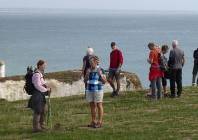Photo of walkers overlooking the chalk cliffs at Handfast Point – September 19, 2026